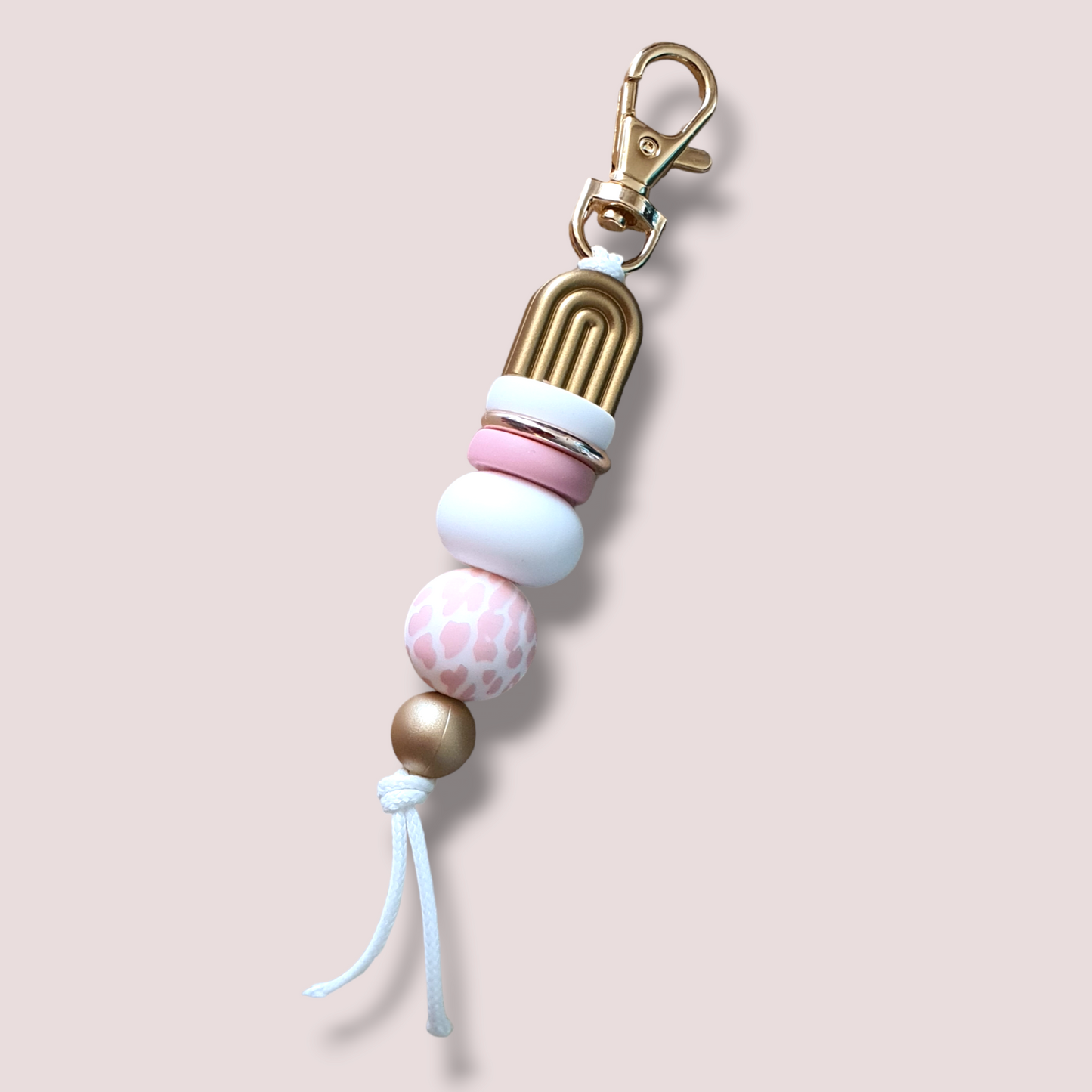 Blush pink cow pirnt and gold keyring featuring tones of white pink and gold